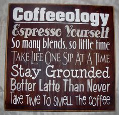 a sign that is on the wall in front of a coffee cup holder with words written below it