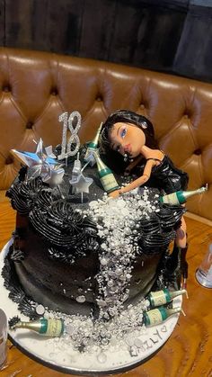 a birthday cake with an image of a woman on top and bottles in the middle