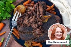 a blue plate topped with meat and carrots next to a fork on top of a wooden table