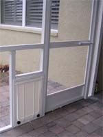 an open sliding glass door in front of a house