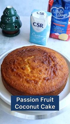 a cake sitting on top of a white plate next to a bag of coconut milk