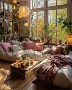 a living room filled with lots of furniture next to a large window covered in plants