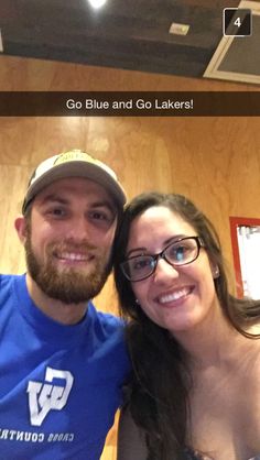 a man and woman taking a selfie in front of a wooden wall with the caption go blue and go lakers