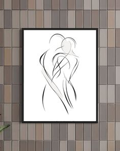 a black and white drawing on a wall next to a vase with flowers in it