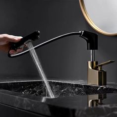 a person is washing their hands under a faucet