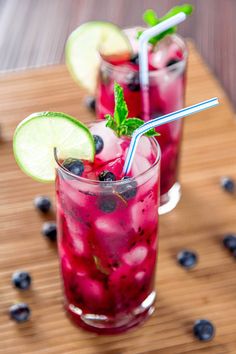 two glasses filled with blueberries and limeade