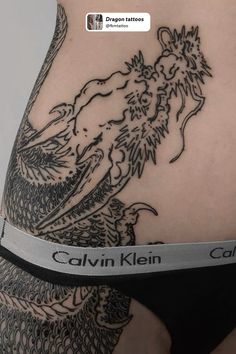 the back of a woman's stomach with tattoos on it and an inscription that reads,