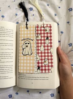 an open book with dogs on it and a tassel hanging from the front cover