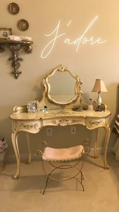 an antique vanity with mirror and stool in a bedroom