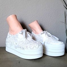 a pair of white shoes sitting on top of a table