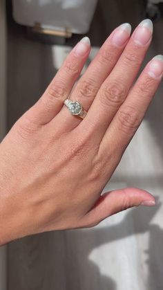 a woman's hand with a ring on it