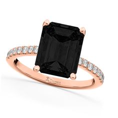 an engagement ring with a black diamond in the center and white diamonds on the sides