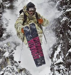 a man flying through the air while riding skis