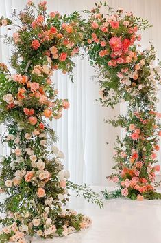 an arch made out of flowers and greenery