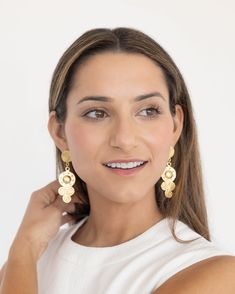 Our Sardinia Drop Earrings were made for dancing! Achieving a look of laid back luxury, these statement earrings capture the essence of an infamous era, the 70s. With whimsical spirals and studded detailing, these earrings add a bold element to any outfit. Brass Clip-on Earrings For Party, Party Brass Clip-on Earrings, Brass Plug Earrings For Party, Clip-on Dangle Chandelier Earrings, Laid Back Luxury, Mixing Metals, Hand Painted Beads, Starfish Necklace, Floral Accessories