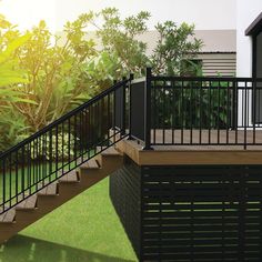 a deck with black railing and green grass