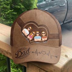 This classic cap is a quintessential accessory for any dad, especially as a Father's Day gift. It boasts a "Best Dad Ever" inscription alongside a heart rate graphic, symbolizing the love and vitality he brings to the family. The cap's unique feature is the personalized section above the visor, where caricatures of children's faces can be placed, each labeled with their names. It's a fashionable and practical way for any father to show off his pride and joy while keeping cool in the sun. MESSAGE Personalized Hats For Father's Day, Flat Bill Hats For Father's Day Gift, Father's Day Gift Snapback Hat With Curved Brim, Father's Day Gift Flat Bill Hat, Personalized Dad Hat With Curved Bill As Gift, Personalized Dad Hat With Curved Bill For Gift, Personalized Curved Brim Baseball Cap For Father's Day, Brown Baseball Cap As A Gift, Brown Curved Bill Hat For Gift