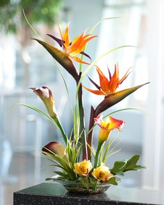 an arrangement of flowers in a vase on a table