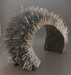 the sculpture is made out of silver sticks