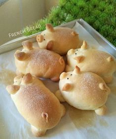 some bread shaped like animals sitting on top of a pan