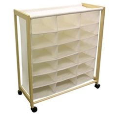 a large white storage unit with wheels and bins on the bottom, for storing items