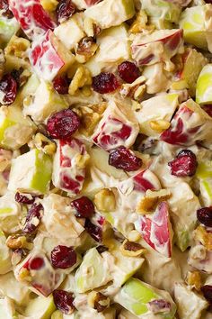 an apple salad with cranberries and walnuts is shown in this close up photo