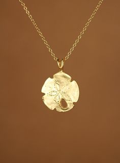 Sand dollar necklace, gold sand dollar pendant, beach necklace, starfish jewelry, a 14k gold vermeil sand dollar on a 14k gold filled chain This dainty gold vermeil gold sand dollar hangs from a 14k gold filled chain in the length of your choice! This beauty is also available in sterling silver and the pendant measures 15mm. Here is a set of super cute sand dollar stud earrings! https://www.etsy.com/listing/151300907/sand-dollar-earrings-stud-earrings-sand?ref=shop_home_active&ga_search_quer Gold Ocean-inspired Round Pendant Jewelry, Ocean-inspired Gold Round Pendant Jewelry, Ocean-inspired Gold Jewelry With Starfish Charm, Gold Sterling Silver Necklace For Beach, Gold Sterling Silver Jewelry For Beach, Yellow Gold Starfish Charm Jewelry For Beach, Gold Starfish Shaped Dainty Jewelry, Dainty Starfish Gold Jewelry, Dainty Gold Starfish Jewelry