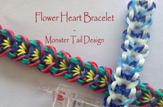 a close up of a piece of art that looks like a flower heart bracelet with monster tail design