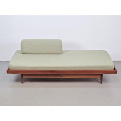 a bed that is sitting on top of a wooden frame with a mattress underneath it