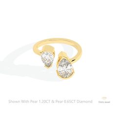 a gold ring with two pear shaped diamonds on the front and side, set against a white background