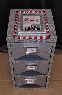 three drawers are stacked on top of each other with red and silver trimmings