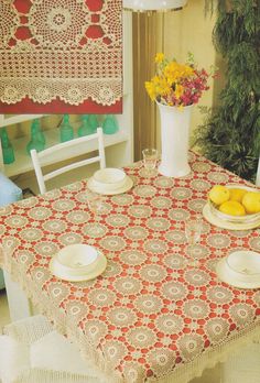 the table is set with plates and bowls of fruit