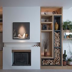 a living room filled with furniture and a fire place in front of a tv mounted on a wall