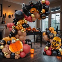 some balloons that are in the shape of pumpkins and bats on a wooden floor