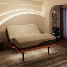 a bed sitting on top of a wooden platform in a bedroom next to a window