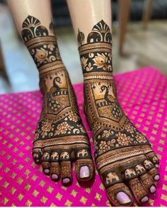 the feet are decorated with henna designs