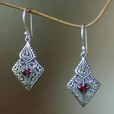 Vibrant red garnets center these elegant sterling silver dangle earrings from Wayan Asmana in Bali. Featuring overlapping diamond shapes reminiscent of Art Deco motifs the leafy openwork has both polished and oxidized areas for contrast..925 Sterling silver Gift Sterling Silver Diamond-shaped Earrings, Diamond-shaped Pierced Jewelry Gift, Red Sterling Silver Filigree Earrings, Ornate Red Sterling Silver Earrings, Sacred Forest, Blue Nile Jewelry, Oxidized Silver Earrings, Bali Jewelry, Silver Chandelier Earrings