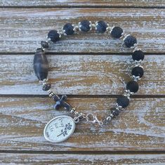 Handcrafted out of Blue Sandstone beads, this is One Decade Rosary Bracelet  Features: * 8 mm Black Crackle Agate * Sacred heart medal. * Durable stainless steel wire This bracelet is 9'' long.  * You may choose to add a Hand stamped charm with the initial of your choice Note: The handcrafted nature of this product will produce minor differences in design, sizing and weight. Variations will occur from piece to piece, measurements may vary slightly. ♥100% Handmade with love♥ Have any questions? Contact the shop owner. Spiritual Rosary Bracelet With Round Beads For Jewelry Making, Handmade Spiritual Bracelets With Oval Beads, Adjustable Spiritual Rosary Bracelet With Spacer Beads, Beaded Rosary Bracelet For Healing, Healing Beaded Rosary Bracelet, Spiritual Rosary Bracelet For Jewelry Making, Adjustable Spiritual Rosary Bracelet With Faceted Beads, Adjustable 8mm Beaded Bracelets, Adjustable Oval Beaded Bracelets