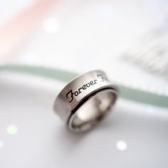 Celebrate the unbreakable bond of friendship with this beautifully crafted "Forever Friends" Spinner Ring. Engraved with a heartfelt message against a sophisticated brushed stainless steel band, this ring is a constant reminder of the cherished relationship you share with your best friend. The smooth spinning feature adds a fun, fidget-friendly element, providing a soothing and engaging sensory experience. Wear this stylish and meaningful ring every day to keep your friend close, even when you'r Minimalist Engraved Stainless Steel Promise Ring, Minimalist Stainless Steel Engraved Promise Ring, Adjustable Stainless Steel Engraved Ring, Adjustable Stainless Steel Engraved Promise Ring, Adjustable Engraved Stainless Steel Rings, Personalized Stainless Steel Engraved Ring For Promise, Stainless Steel Promise Rings For Valentine's Day, Valentine's Day Promise Ring In Stainless Steel, Stainless Steel Ring With Brushed Finish As Gift