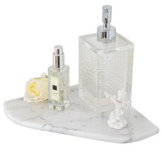 a white marble counter top with two bottles and a soap dispenser