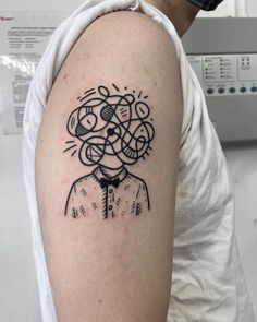 a person with a tattoo on their arm that has an image of a man's head