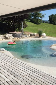 an outdoor swimming pool with people in it