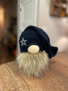 a blue hat with a star on it sitting on top of a wooden table