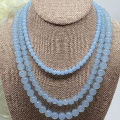 Indulge in the timeless elegance of the Amicae Blue Single Strand Necklace - a handcrafted crystal glass masterpiece that exudes sophistication with every single strand - The icy blue hue of the beads brings images of clear winter skies. In contrast, the single-strand design adds a touch of simplicity to this work. Whether you're attending your best friend's wedding or dressing for an important business meeting, the Amicae Blue Necklace will surely be your go-to accessory for that perfect finish Elegant Blue Gemstone Bead Crystal Necklace, Elegant Blue Crystal Necklaces With Gemstone Beads, Blue Double Strand Spiritual Necklace, Elegant Blue Necklace With 8mm Beads, Elegant Blue Necklaces With 8mm Beads, Elegant Light Blue Single Strand Beaded Necklace, Elegant Blue Crystal Necklaces With Round Beads, Elegant Blue Necklace With Round Beads, Elegant Blue Crystal Necklace With Round Beads