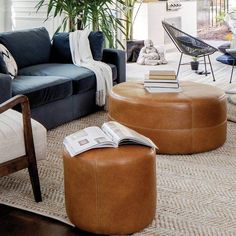 a living room filled with lots of furniture and books on top of a coffee table