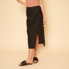 The Valentina Skirt Is A Linen Mid-Length Wrap Skirt. Versatile Black Asymmetrical Skirt Bottoms, Versatile Black Asymmetrical Skirt, Chic Black Asymmetrical Wrap Skirt, Black Lined Relaxed Skirt Bottoms, Black Summer Pencil Skirt, Chic Black Summer Pencil Skirt, Chic Black Pencil Skirt For Day Out, Versatile Black Midi Skirt, Long Black Pencil Skirt For Spring