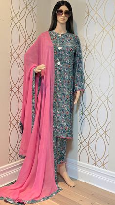 A stunning 3 piece Linen casual wear stitched outfit with pure chiffon dupatta.  COLOR: Ferozi/ Pink A-line style stitched shirt. Linen fabric shirt finished with lace trim on hemline and sides .  Long bell bottom sleeves finished with Lace trim. Matching printed straight trouser. Pure chiffon dupatta finished with matching lace trim all around.  MEASUREMENT: Shirt length:          43 inches Large chest:           21 inches Medium chest:       20 inches Trouser length:        37 inches   NOTE: Bell Bottom Sleeves, Kylie Jenner Baby, Shirt Linen, Pure Chiffon, Stitch Shirt, Chiffon Dupatta, Linen Casual, Pakistani Designers, Straight Trousers