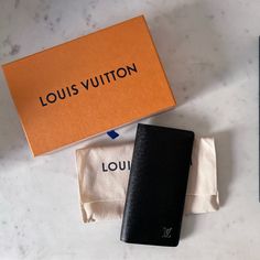 Brand New, Never Used, Taiga Leather With Chrome Monogram. Long Wallet. Purchased At Louis Vuitton Barcelona. Box, Dust Bag, And Cards Within The Wallet. Piping And Leather In New Condition. Luxury Black Wallets For Daily Use, Black Wallets For Everyday Use, High-end Black Wallet For Formal Occasions, Modern Black Wallet With Dust Bag, High-end Black Wallet For Everyday Use, Bags Louis Vuitton, Louis Vuitton Bags, Long Wallet, Piping