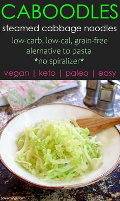 a white plate topped with shredded cabbage next to a wooden spoon