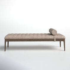 an upholstered bench with two pillows on the back and one pillow on top